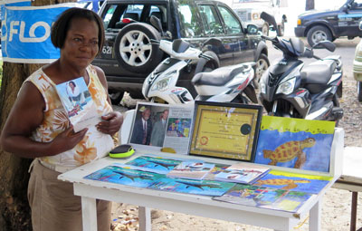 Selma by her stall near the almond tree car park, with a few of her latest books.